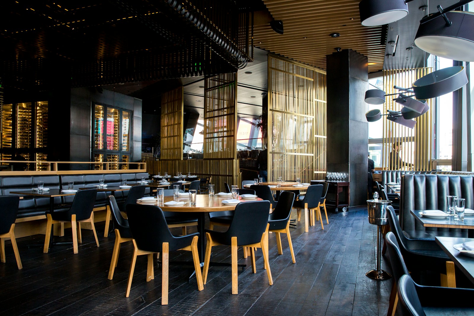 Warm restaurant interior with communal tables and welcoming lighting